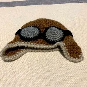 Newborn/infant hand knit aviator cap.